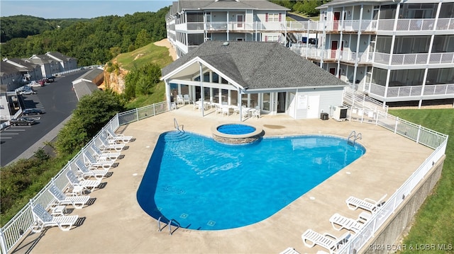 view of pool with a patio and central AC unit