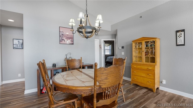 dining area featuring dark wood-type flooring and a chandelier