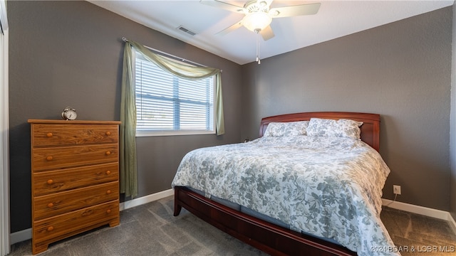 bedroom featuring ceiling fan and dark colored carpet