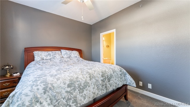 carpeted bedroom featuring ensuite bath, ceiling fan, and vaulted ceiling