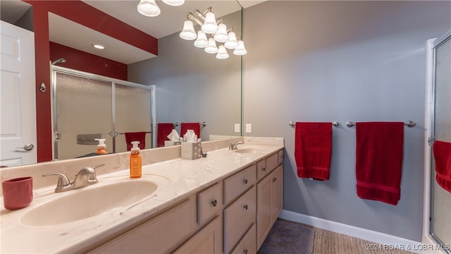 bathroom featuring vanity and an enclosed shower