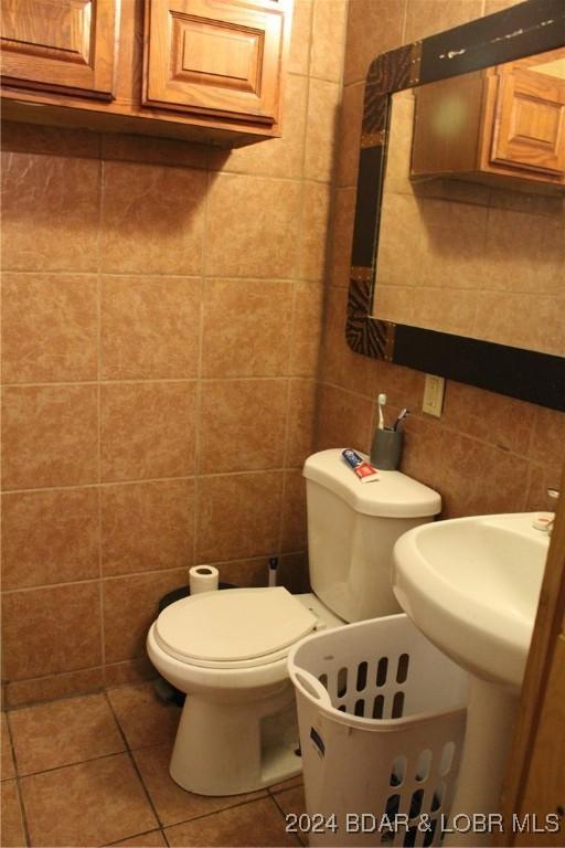 33616 Ray Rd, Stover, MO 65078 - half bathroom featuring tile walls, tile patterned floors, and toilet