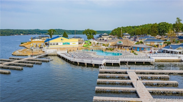 dock area featuring a water view and a community pool