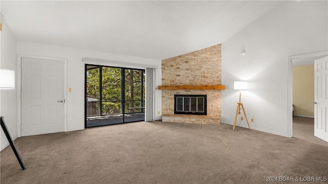 unfurnished living room with carpet floors, high vaulted ceiling, and a large fireplace