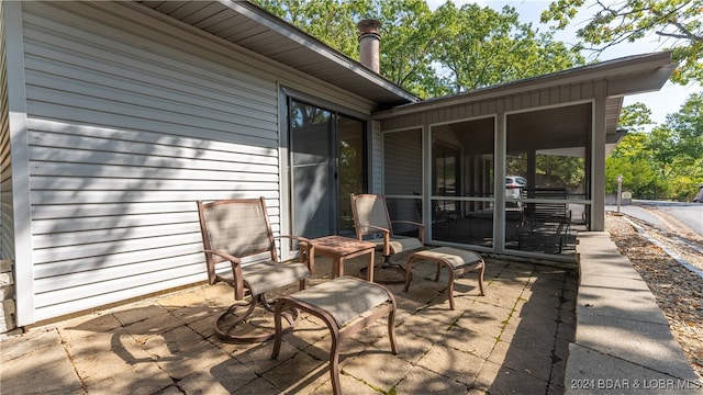 view of patio featuring a sunroom