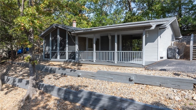 view of front of property featuring a sunroom