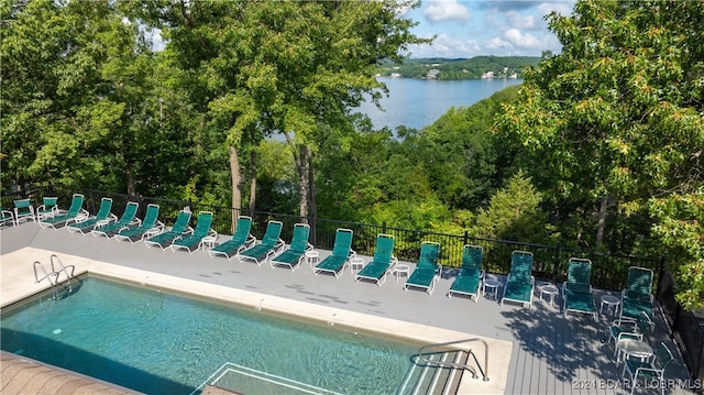 view of pool with a water view