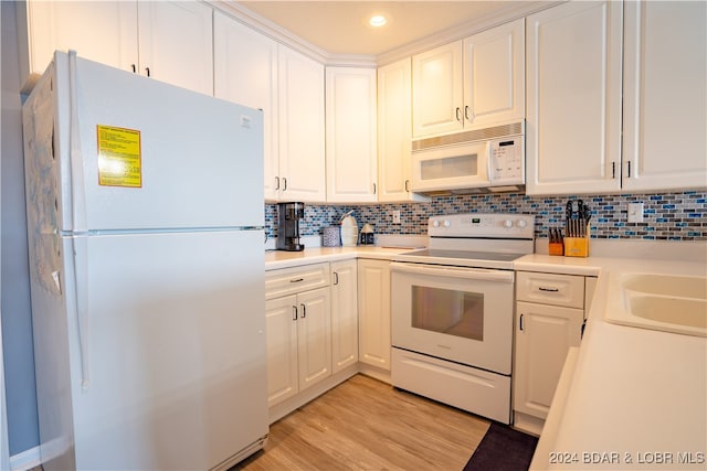 kitchen with decorative backsplash, white cabinets, white appliances, and light hardwood / wood-style floors