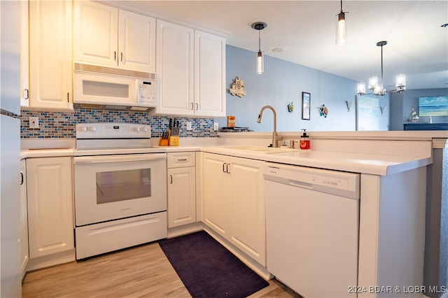 kitchen featuring light hardwood / wood-style floors, white cabinetry, a chandelier, and white appliances