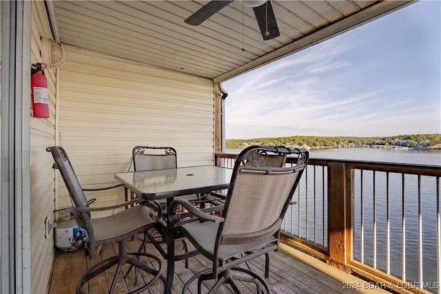 wooden terrace featuring a water view and ceiling fan