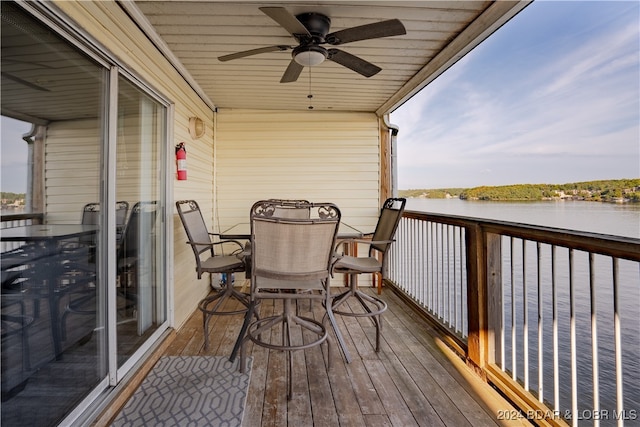 balcony with a water view and ceiling fan