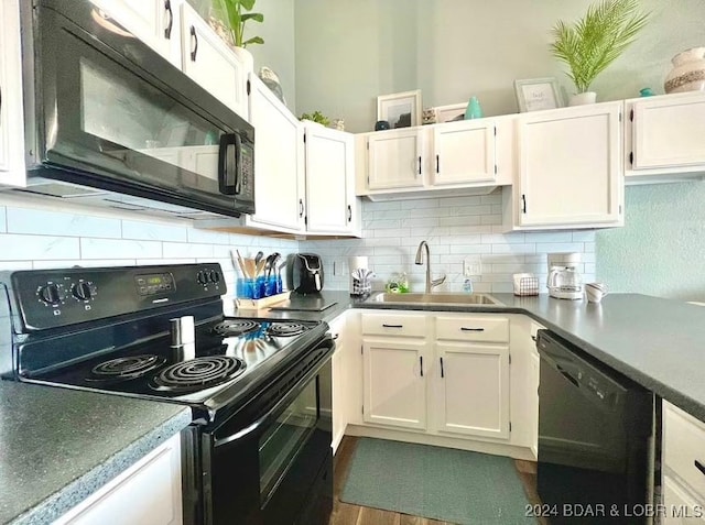 kitchen with decorative backsplash, white cabinets, dark hardwood / wood-style flooring, black appliances, and sink