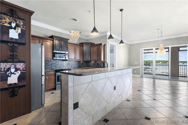 kitchen featuring decorative backsplash, appliances with stainless steel finishes, decorative light fixtures, and crown molding