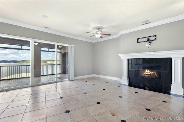 unfurnished living room with ornamental molding, ceiling fan, light tile patterned flooring, and a fireplace