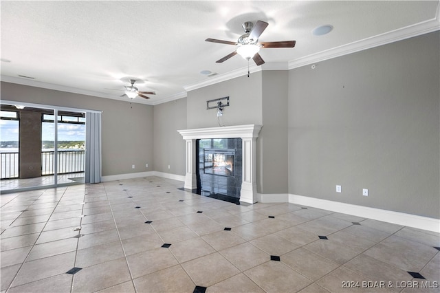 unfurnished living room with ceiling fan, a textured ceiling, crown molding, and a high end fireplace