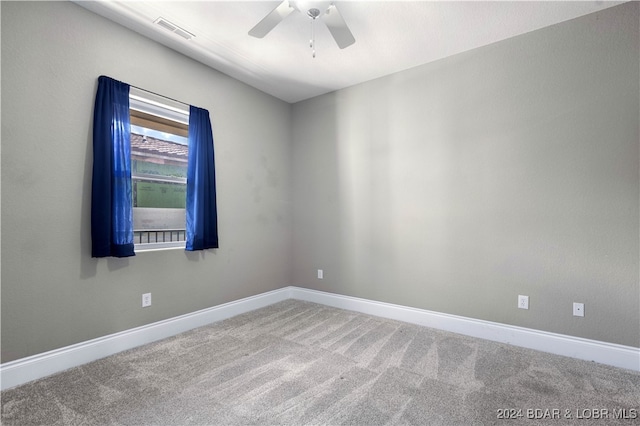 empty room with ceiling fan and carpet floors