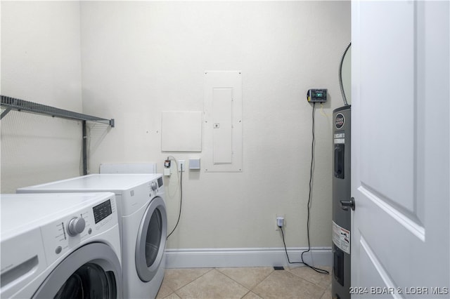 laundry area featuring electric panel, washer and dryer, and light tile patterned flooring