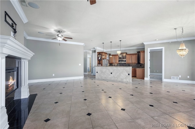 unfurnished living room with ceiling fan with notable chandelier, ornamental molding, and light tile patterned floors