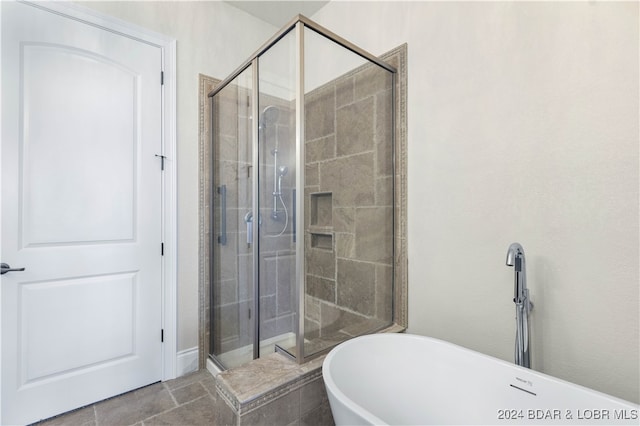 bathroom featuring shower with separate bathtub