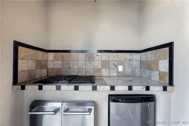 kitchen with exhaust hood, stainless steel fridge, and decorative backsplash