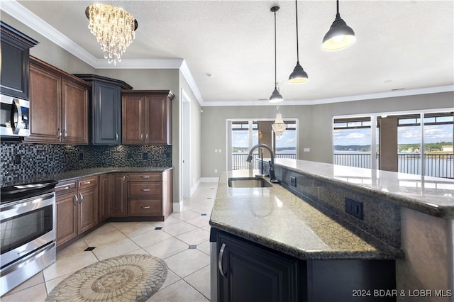 kitchen with appliances with stainless steel finishes, sink, pendant lighting, and plenty of natural light