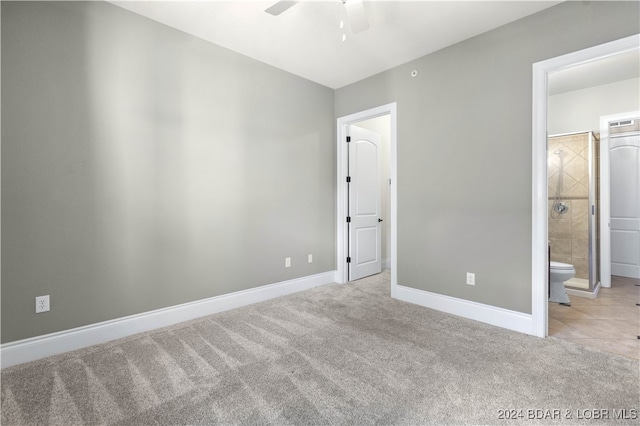 unfurnished bedroom with connected bathroom, ceiling fan, and light colored carpet