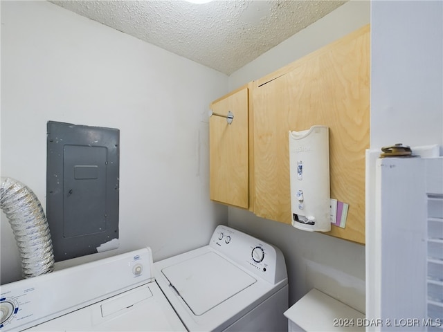 laundry room with cabinets, electric panel, washing machine and clothes dryer, and a textured ceiling