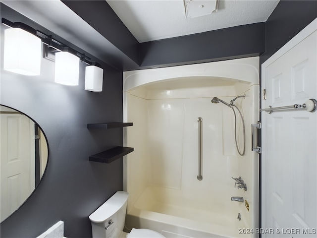 bathroom featuring a textured ceiling,  shower combination, and toilet