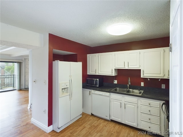 kitchen with light wood-type flooring, white appliances, white cabinetry, and sink