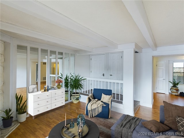 sitting room with beamed ceiling and dark hardwood / wood-style flooring