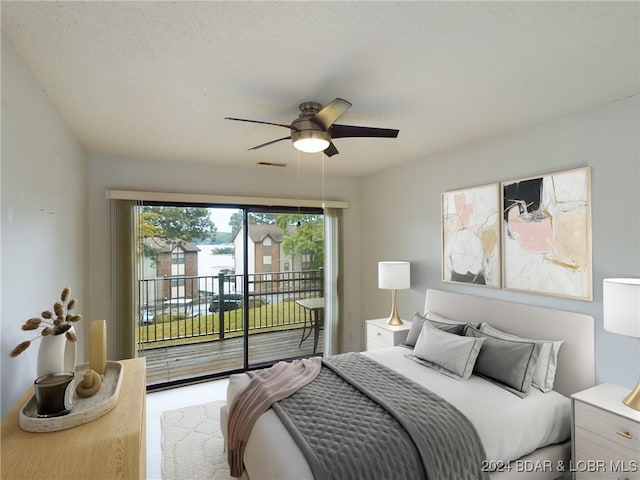 bedroom with a textured ceiling, access to outside, and ceiling fan