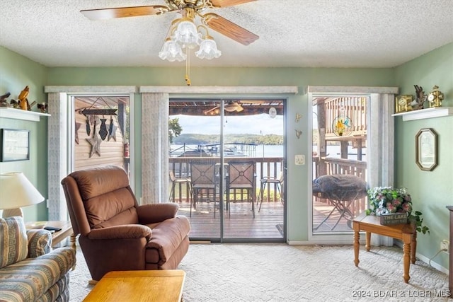 interior space with light carpet, a textured ceiling, and ceiling fan