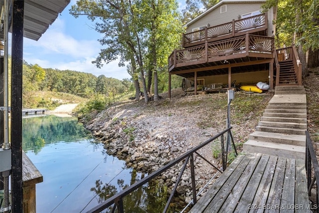 view of dock with a deck with water view