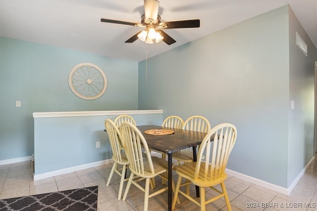 tiled dining area featuring ceiling fan