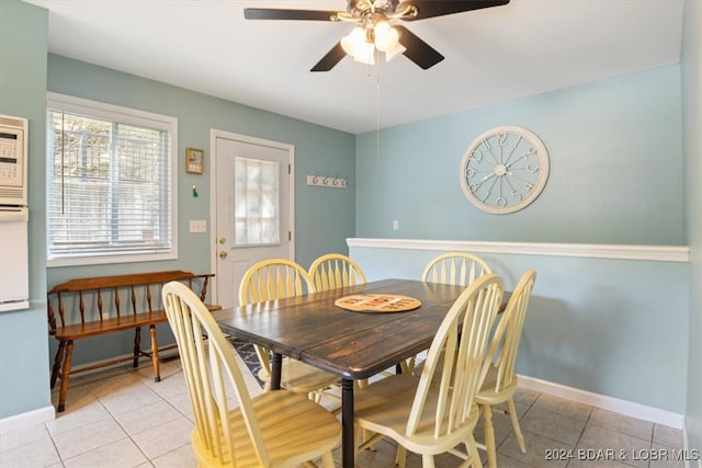 dining space with light tile patterned flooring and ceiling fan