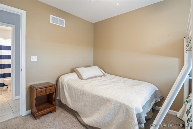 carpeted bedroom featuring ensuite bath