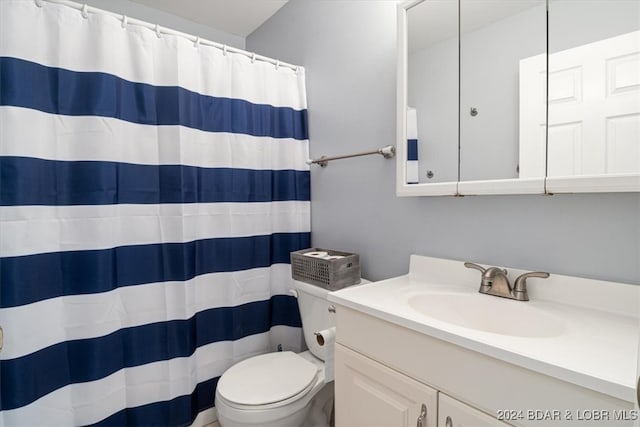 bathroom featuring vanity, toilet, and a shower with curtain