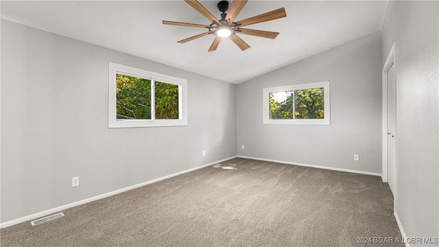 carpeted spare room with lofted ceiling and ceiling fan