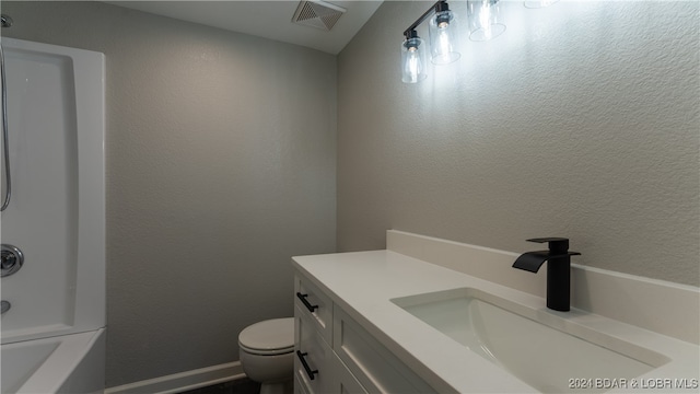 full bathroom with shower / washtub combination, vanity, and toilet