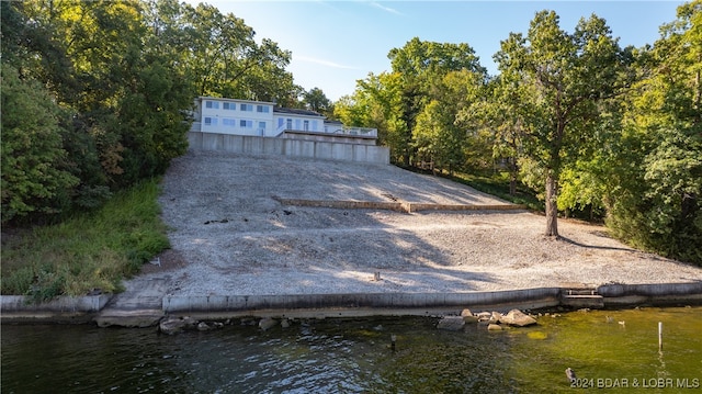 rear view of property featuring a water view