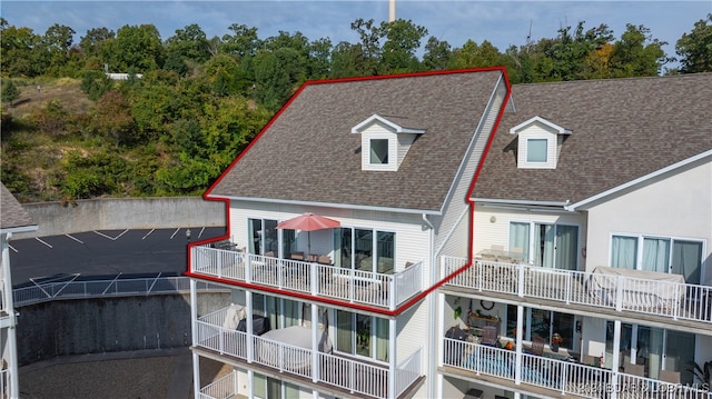 rear view of property featuring a balcony