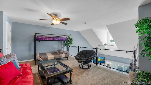 carpeted bedroom with vaulted ceiling and ceiling fan