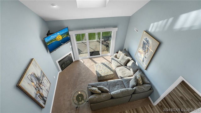 living room featuring vaulted ceiling and hardwood / wood-style floors