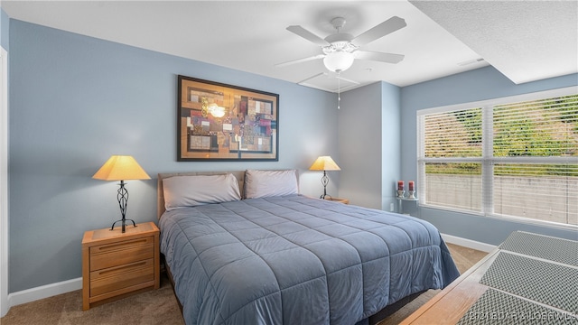 bedroom featuring ceiling fan and carpet