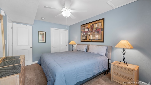 carpeted bedroom featuring ceiling fan and a closet