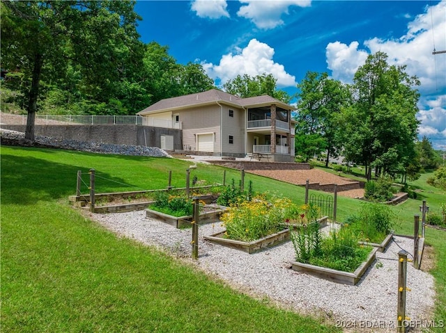 exterior space with a balcony, a garage, and a lawn