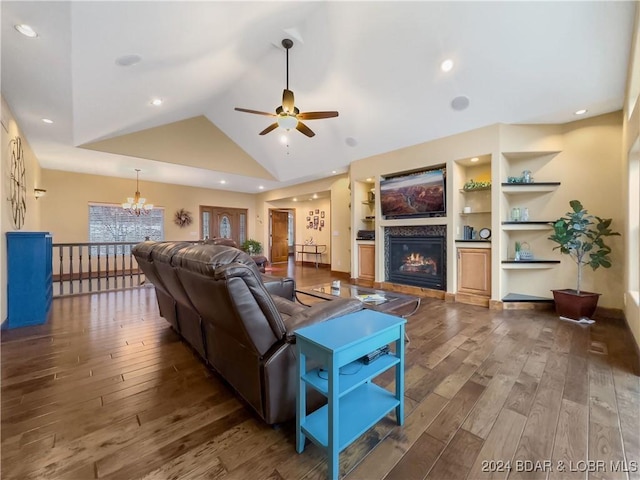 living room featuring ceiling fan with notable chandelier, dark hardwood / wood-style floors, built in features, and high vaulted ceiling