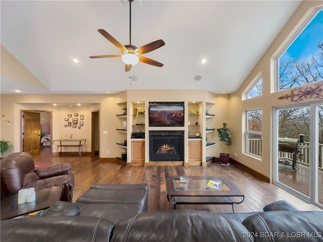 living room featuring ceiling fan, dark hardwood / wood-style flooring, and high vaulted ceiling