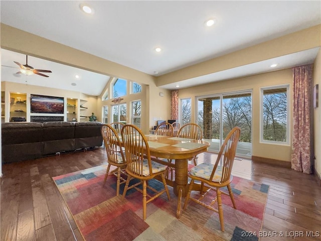 dining space featuring built in shelves, dark hardwood / wood-style flooring, vaulted ceiling, and ceiling fan