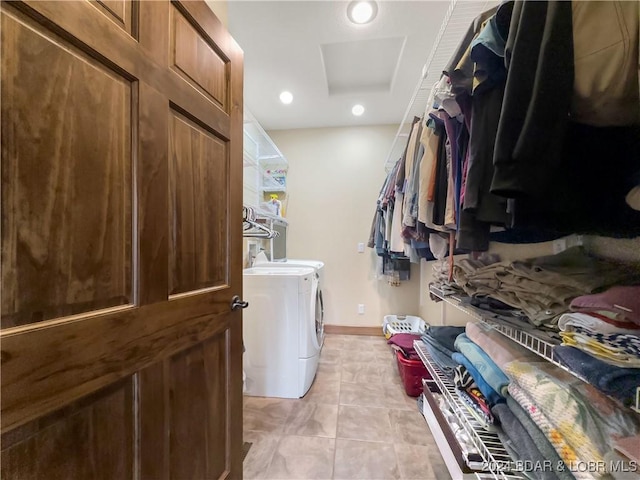 laundry area with light tile patterned floors and independent washer and dryer